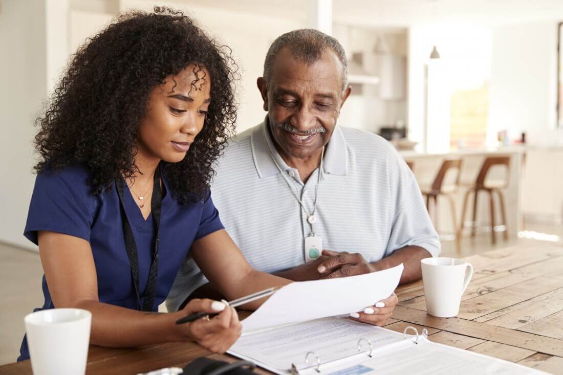 Assisted Living Caregiver Reviewing Paperwork with Senior Resident at Moraine Ridge