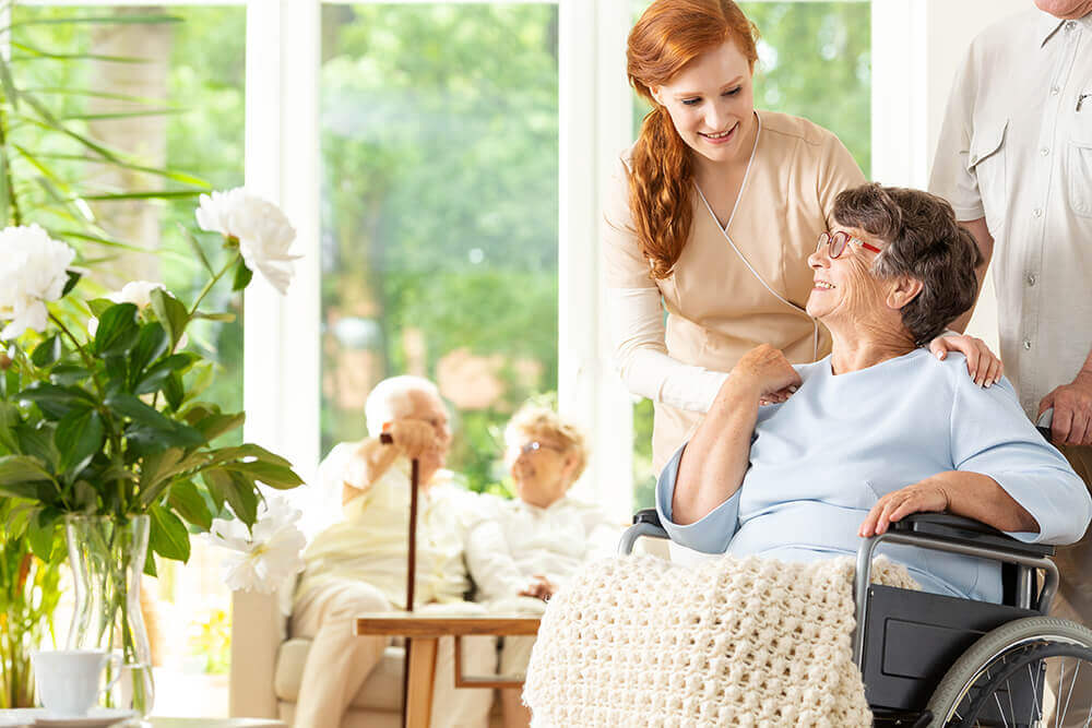 Moraine Ridge Senior Living Caregiver Helping Resident in Wheelchair